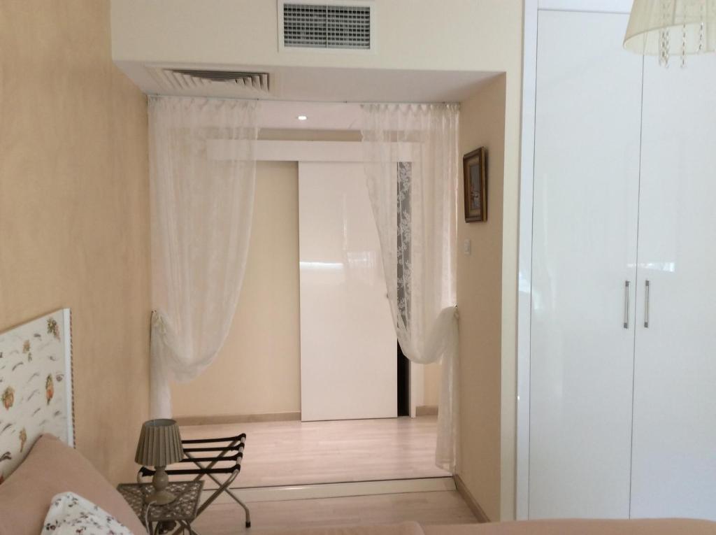 Sliding door with lace drapes between bedroom and hallway at the Fantasia Suite Nicosia
