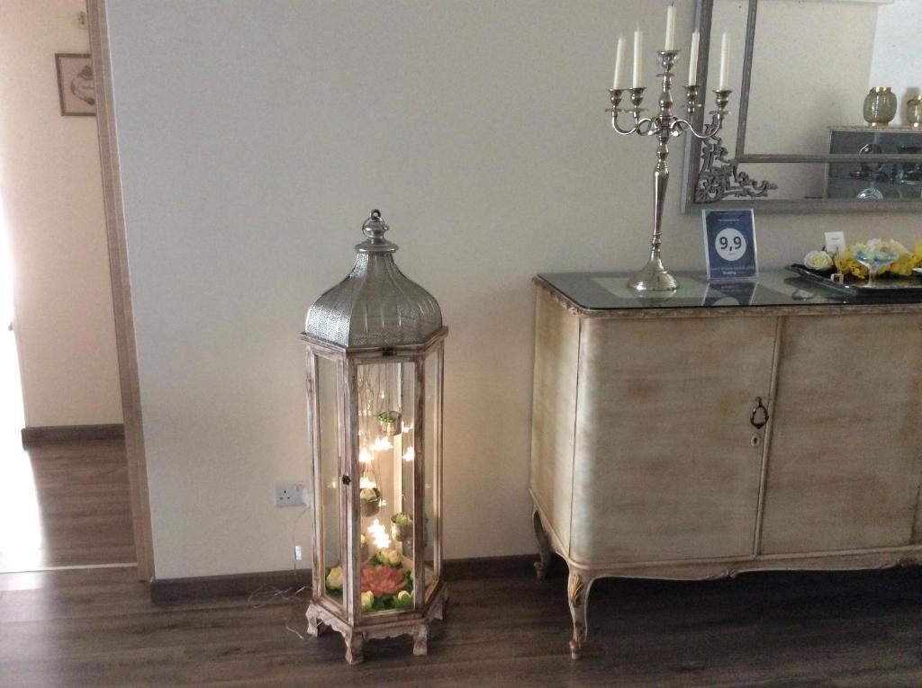 Decorative lantern and candelabra by the sideboard at the Vintage Central Suite Nicosia