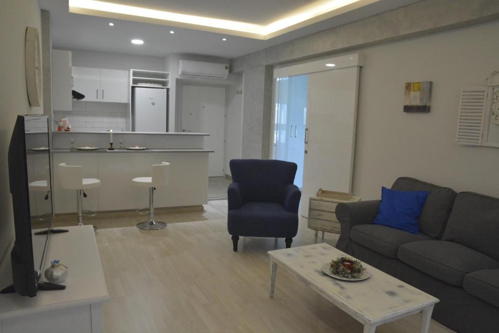 Armonia Suite open plan living and kitchen with blue armchair in central Nicosia apartment