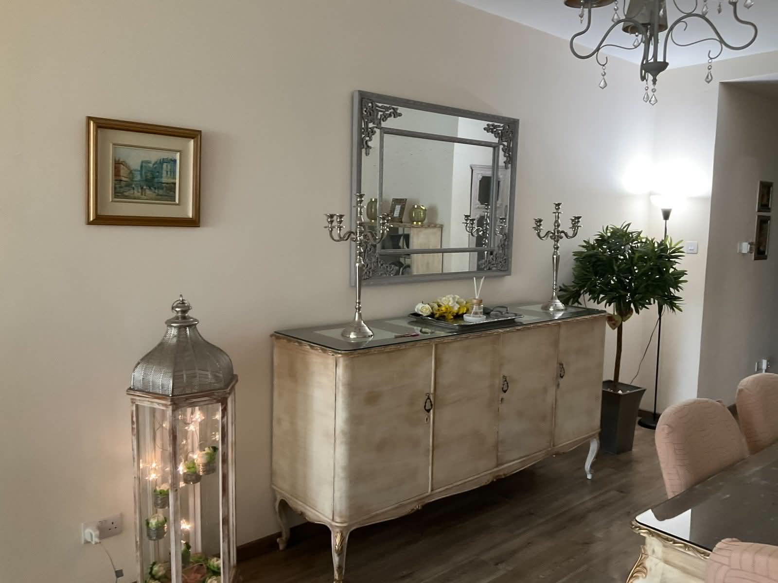 Dining area with antique sideboard, ornate mirror and chandelier at the Vintage Central Suite Nicosia