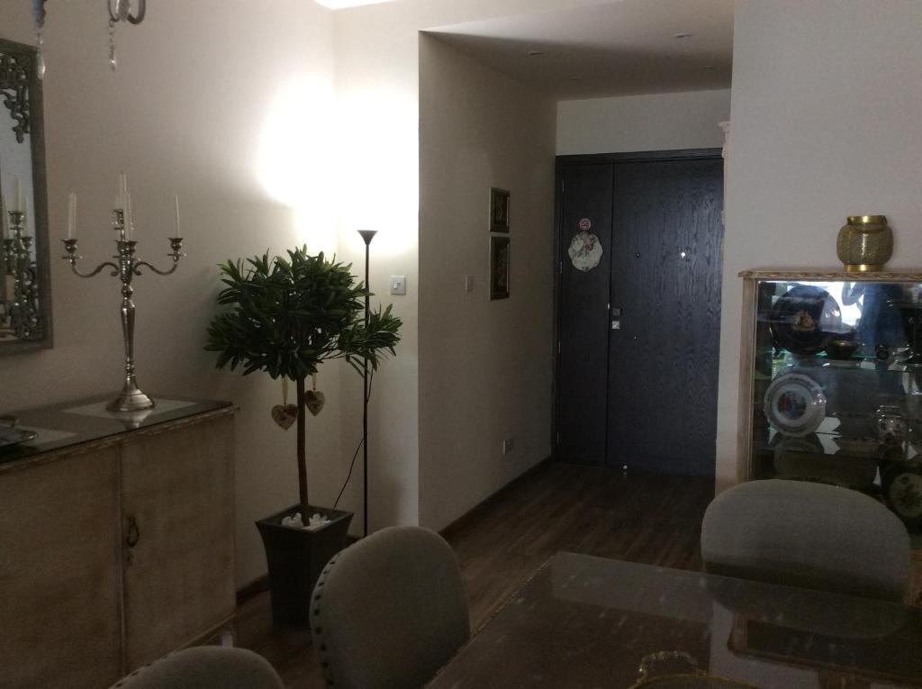 Entry hall with floor lamp, candelabra and display cabinet at the Vintage Suite Nicosia