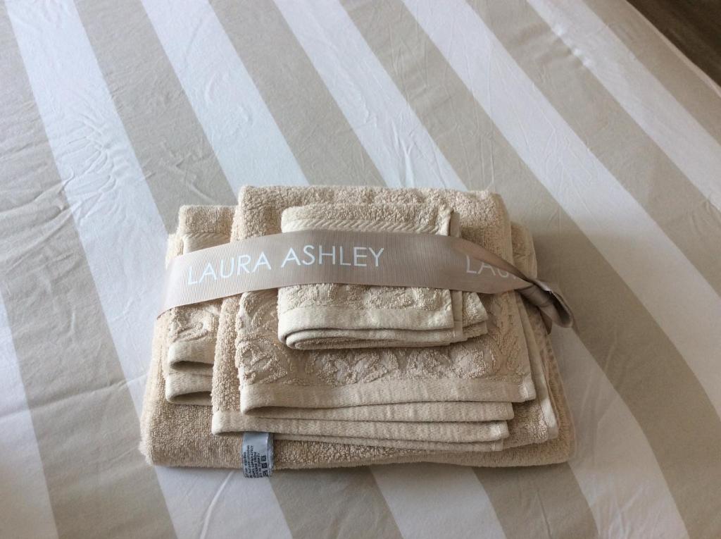 Fresh Laura Ashley towels on striped bedding at the Vintage Central Suite Nicosia