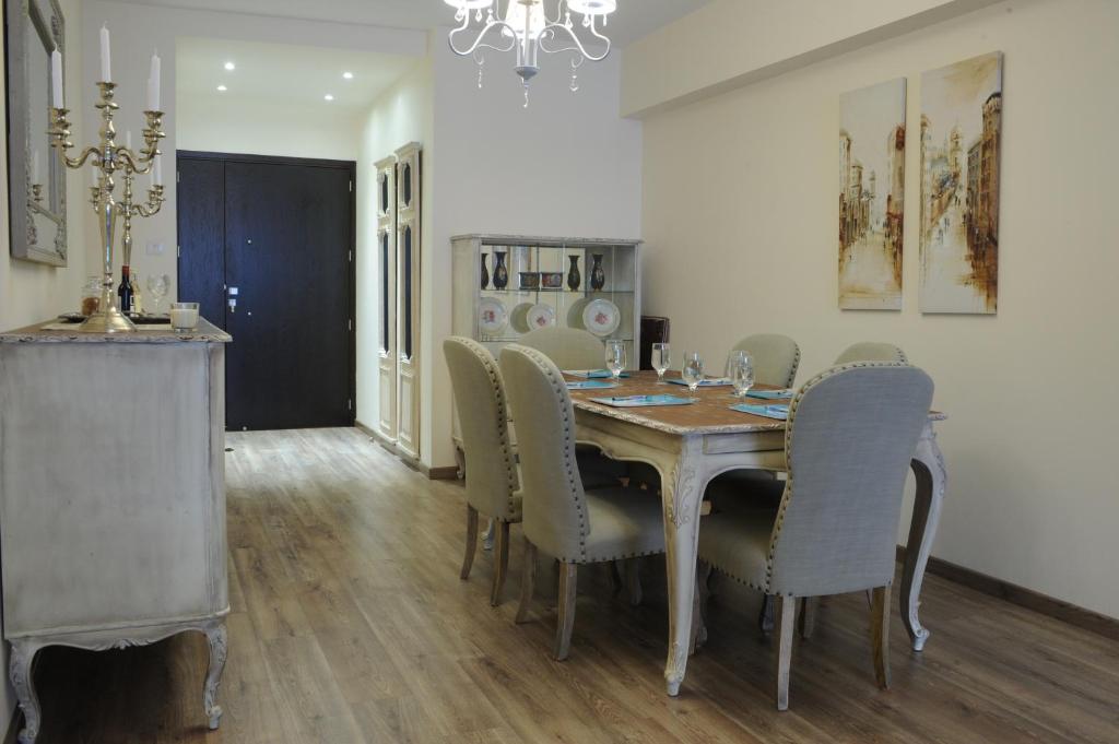 Dining room and entrance hall with chandelier and city artwork at the Vintage Central Suite Nicosia