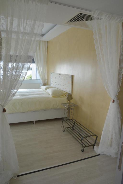 Fantasia Suite bedroom with soft yellow walls and lace canopy in central Nicosia Cyprus