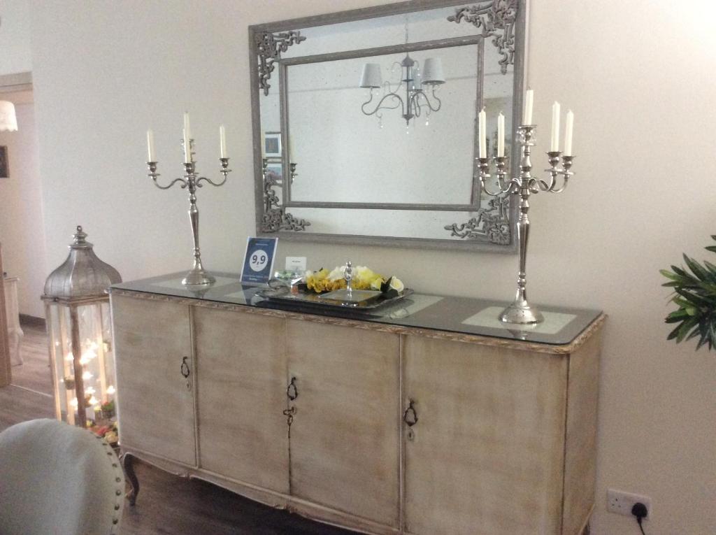 Antique sideboard with candelabras and mirror in the Vintage Central Suite Nicosia