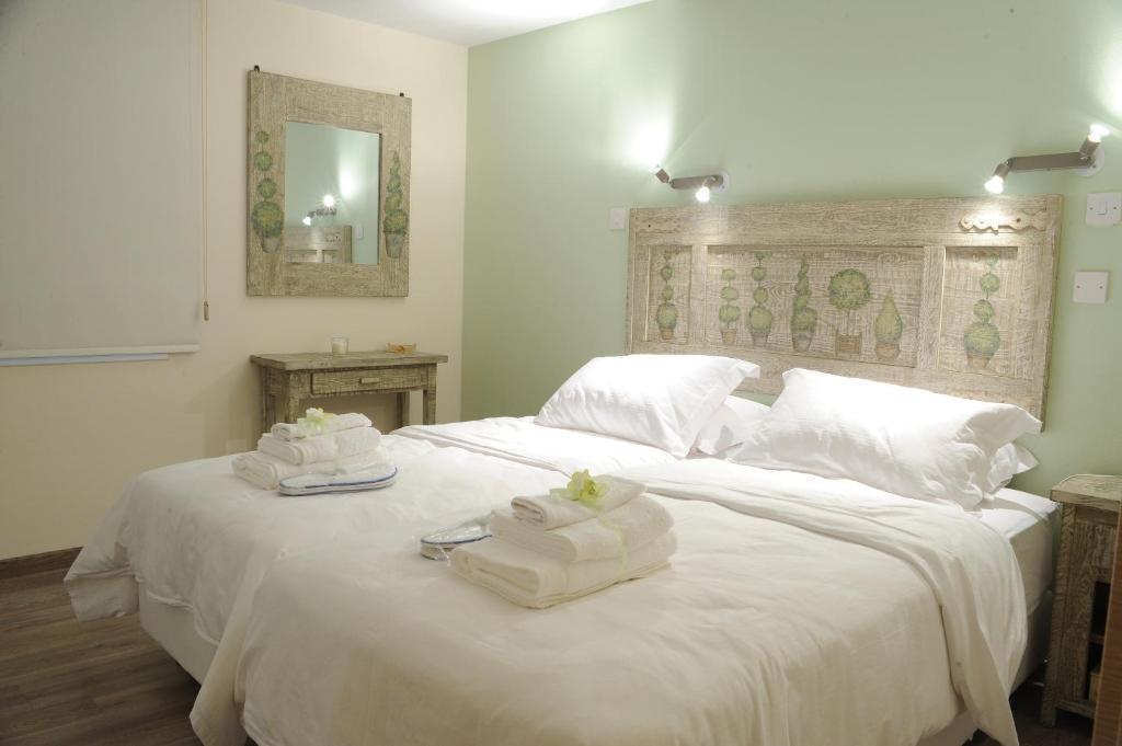 Vintage Suite double bedroom with carved headboard and crisp white linen in central Nicosia