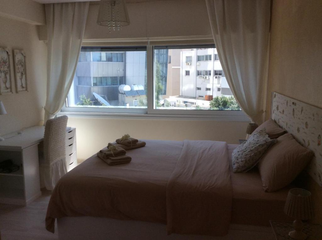 Fantasia Suite double bed with fresh towels and city skyline view in central Nicosia