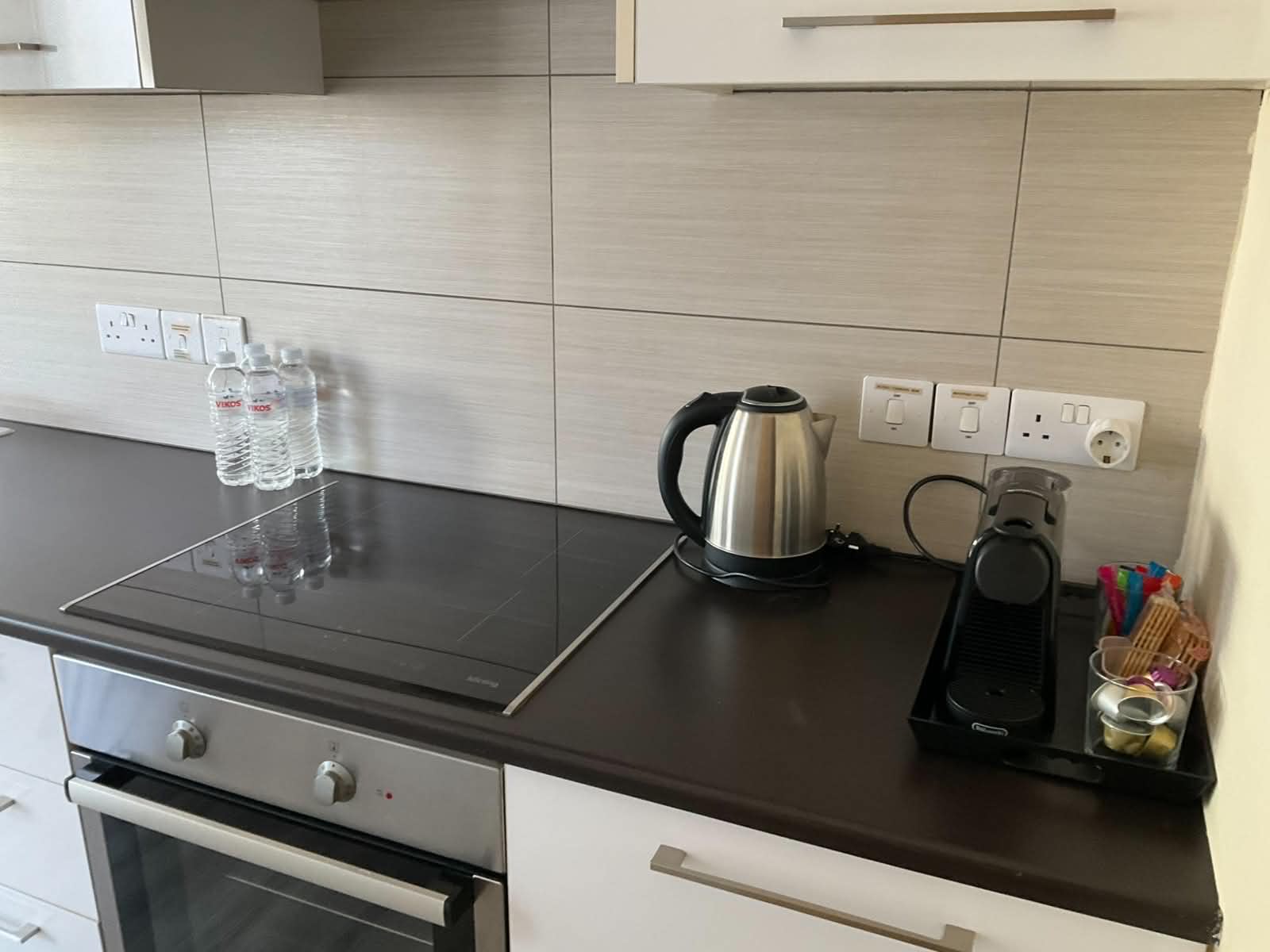 Fully equipped kitchen with induction hob, oven and Nespresso machine at the Vintage Suite Nicosia