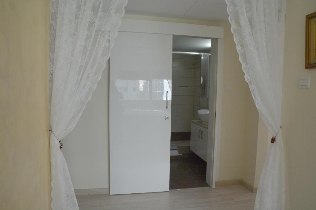 Sliding door to the Fantasia Suite bathroom with walk-in shower in central Nicosia