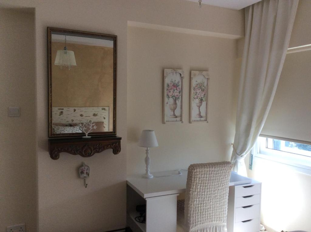 Fantasia Suite vanity desk with antique mirror and floral art in central Nicosia apartment