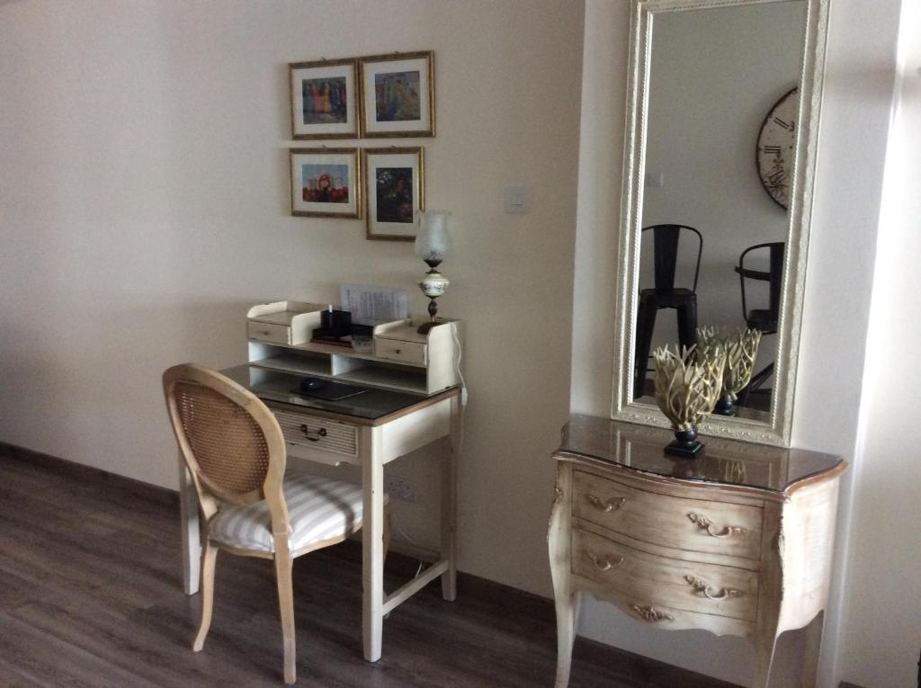 Writing desk with cane chair and mirror in the Vintage Central Suite Nicosia