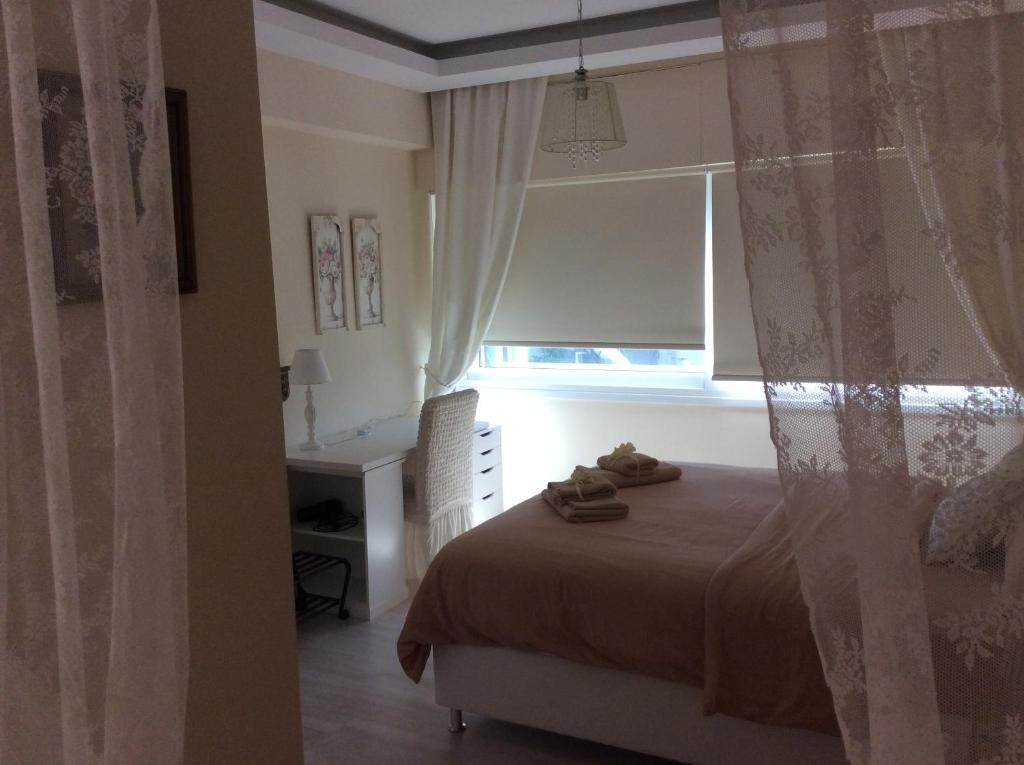 Fantasia Suite bedroom with lace canopy and large window in central Nicosia apartment