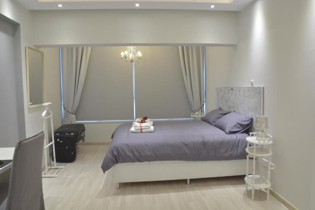Armonia Suite bedroom with chandelier and large window in central Nicosia apartment