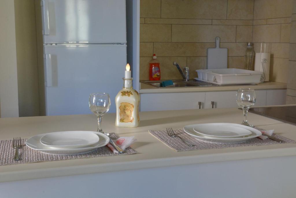Dining bar set for two with candle and wine glasses at the Fantasia Suite Nicosia