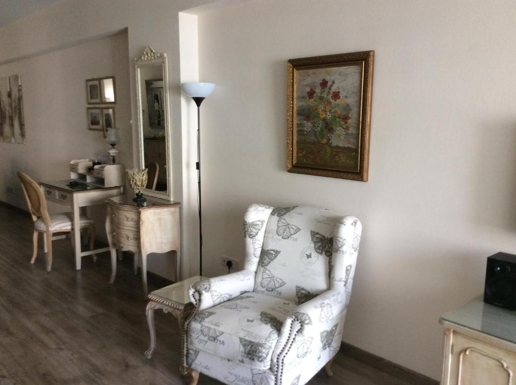 Butterfly print armchair and floor lamp in the Vintage Suite living area, central Nicosia
