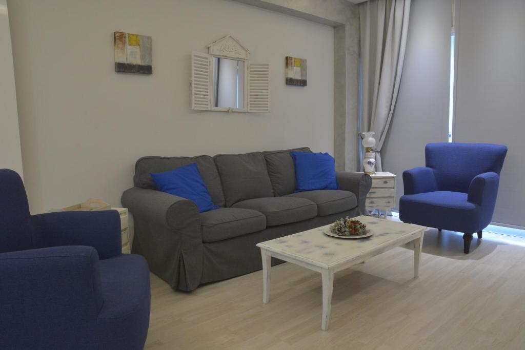 Armonia Suite living room with grey sofa and blue armchairs in central Nicosia Cyprus