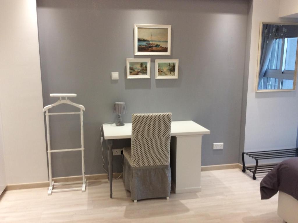 Writing desk with framed seascape art in the Armonia Central Suite Nicosia bedroom