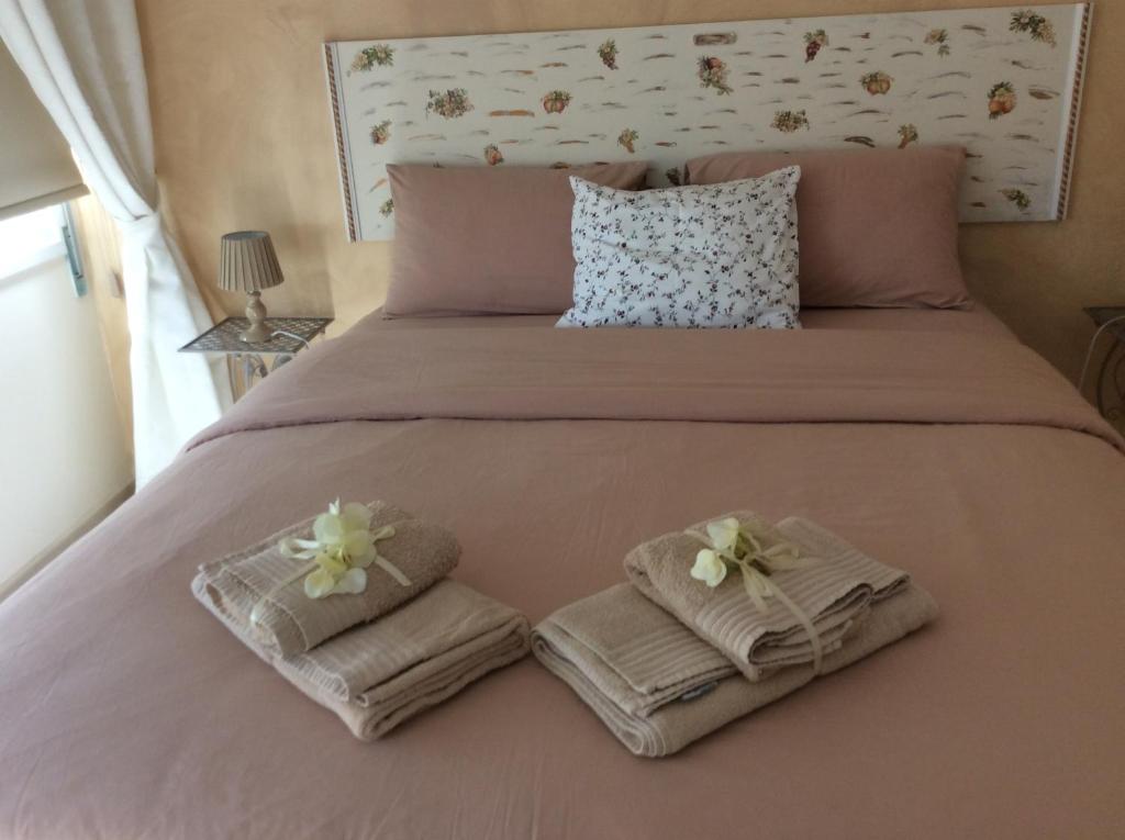 Fantasia Suite double bed with fresh towels and floral headboard in central Nicosia