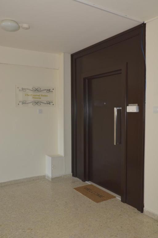 Building entrance with The Central Suites Nicosia plaque welcoming Armonia Suite guests