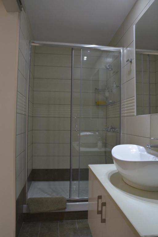 Armonia Suite bathroom with walk-in glass shower and vessel sink in central Nicosia
